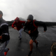 People run as waves hit the coast of Sao Mateus.